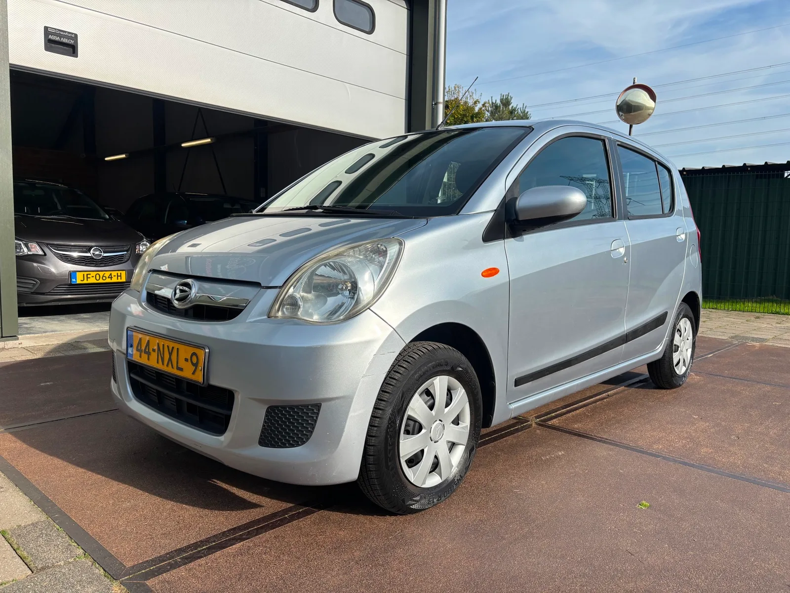 Daihatsu Cuore (2011) — foto 1