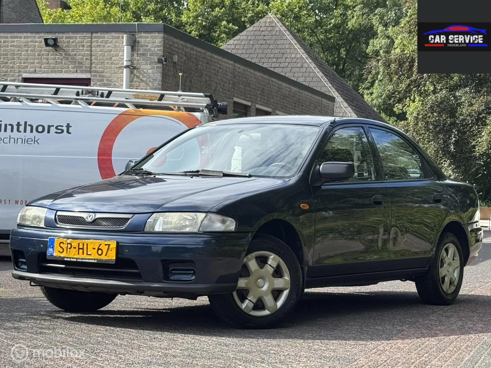 Mazda 323 (1998) — foto 1