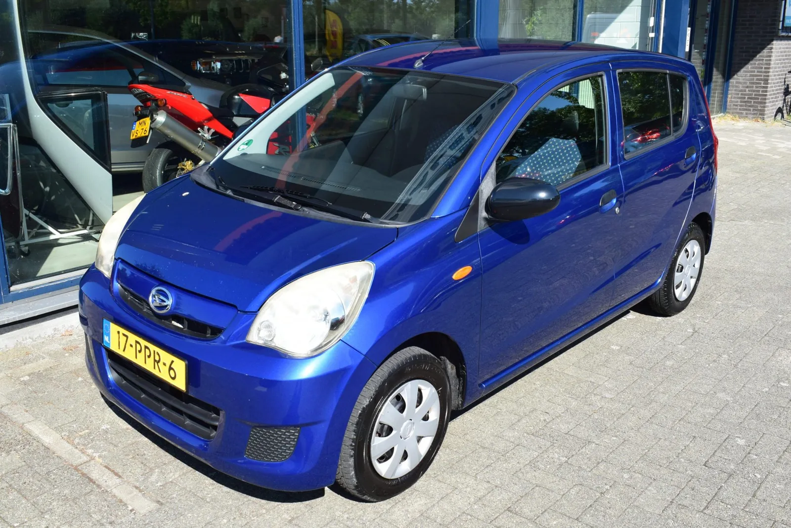 Daihatsu Cuore (2011) — foto 1